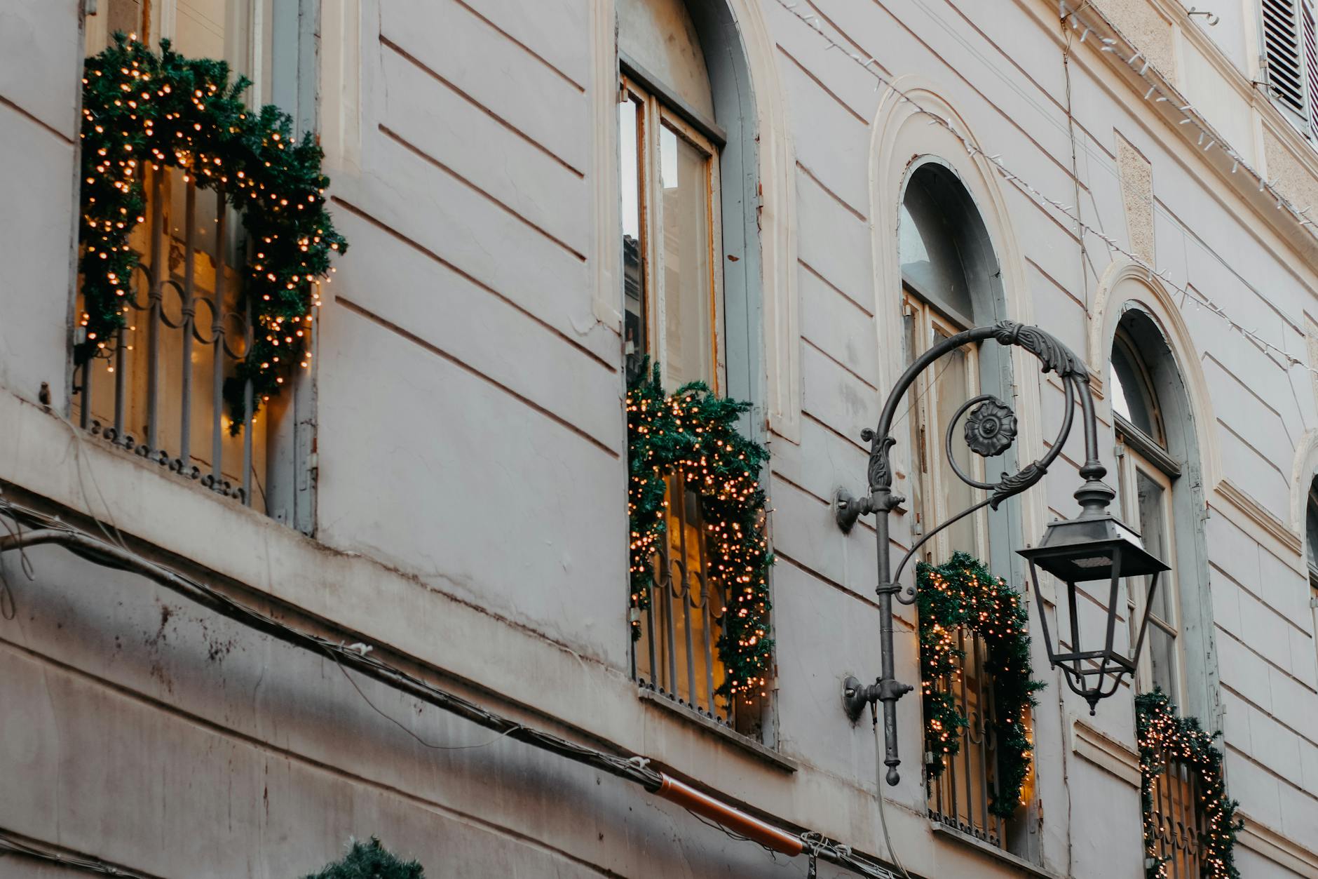 christmas decorations on the balconies of a city building